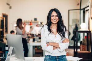Confident woman business leader in a busy workspace